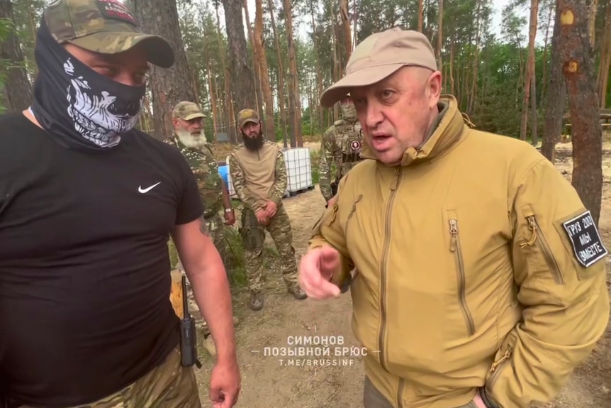 El jefe de la compañía militar del Grupo Wagner, Yevgeny Prigozhin, habla con los combatientes en una zona boscosa.