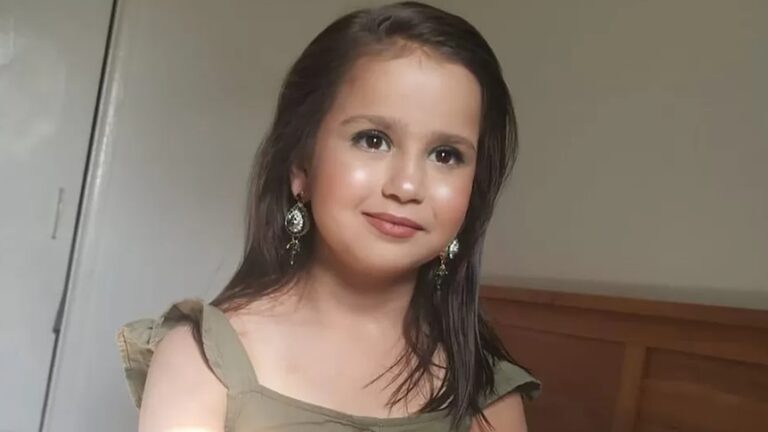 a 10-year-old girl wearing earrings and makeup