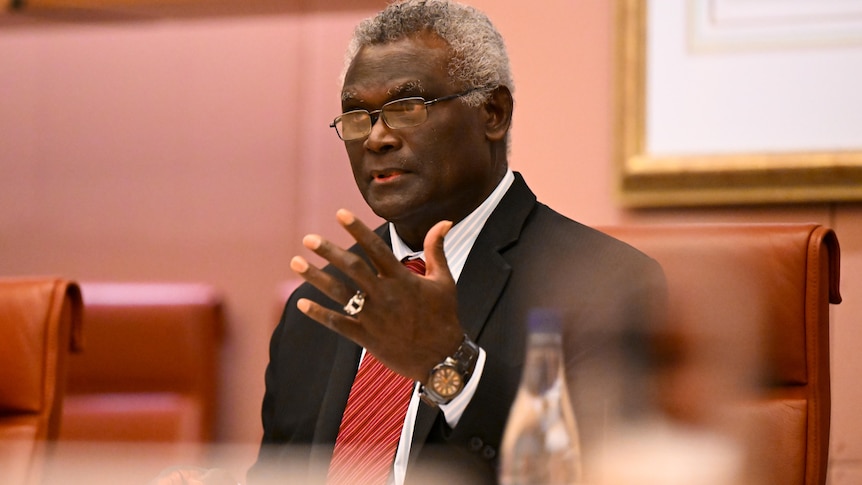 Manasseh Sogavare gestures while speaking.