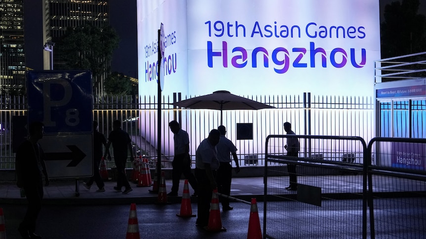 Sign reading "19th Asian Games Hangzhou" lit up at night