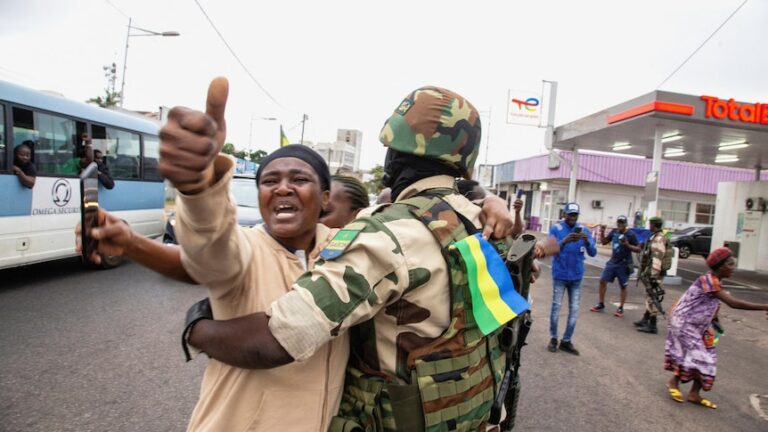 A woman embraces a soldier as she celebrates in Gabon.